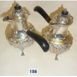 Pair of finely chased repoussé silver chocolate pots with ebonised handles, hallmarked for London