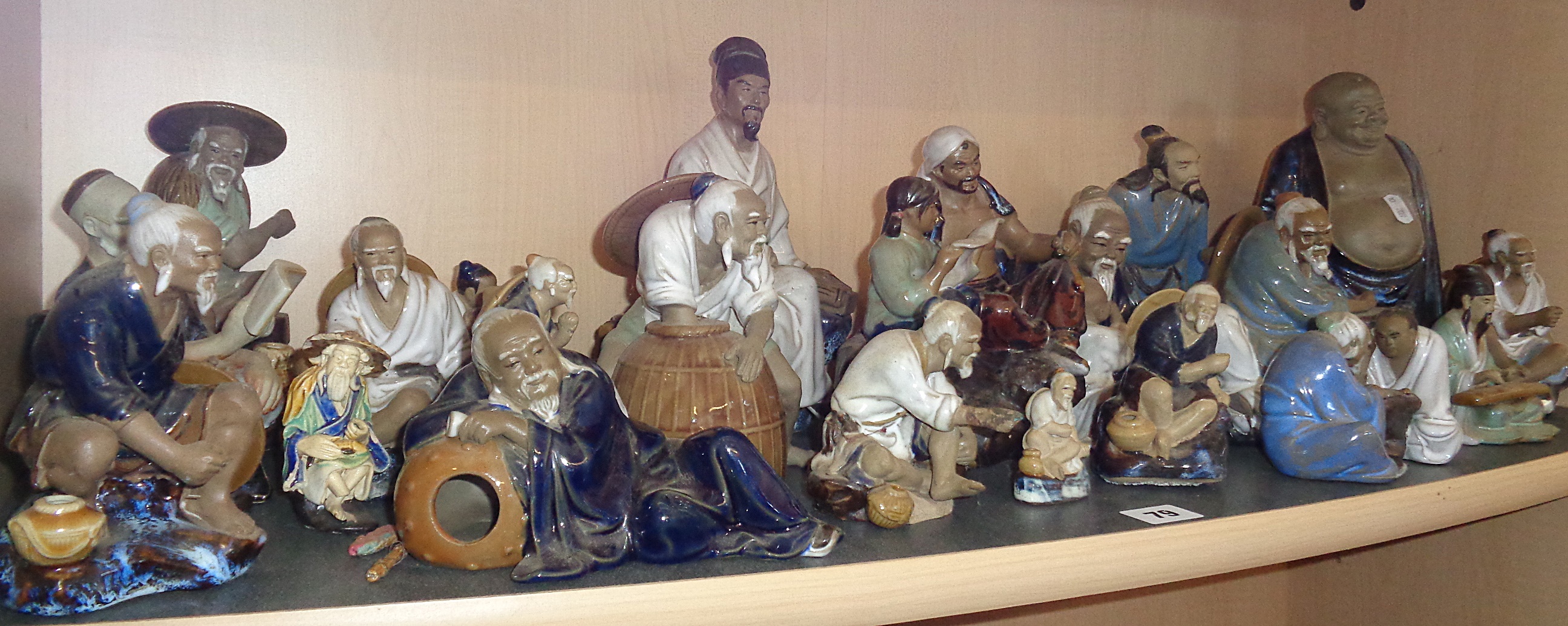 Collection of Japanese pottery 'Mud Men' figures including 'Go' players, fishermen and musicians