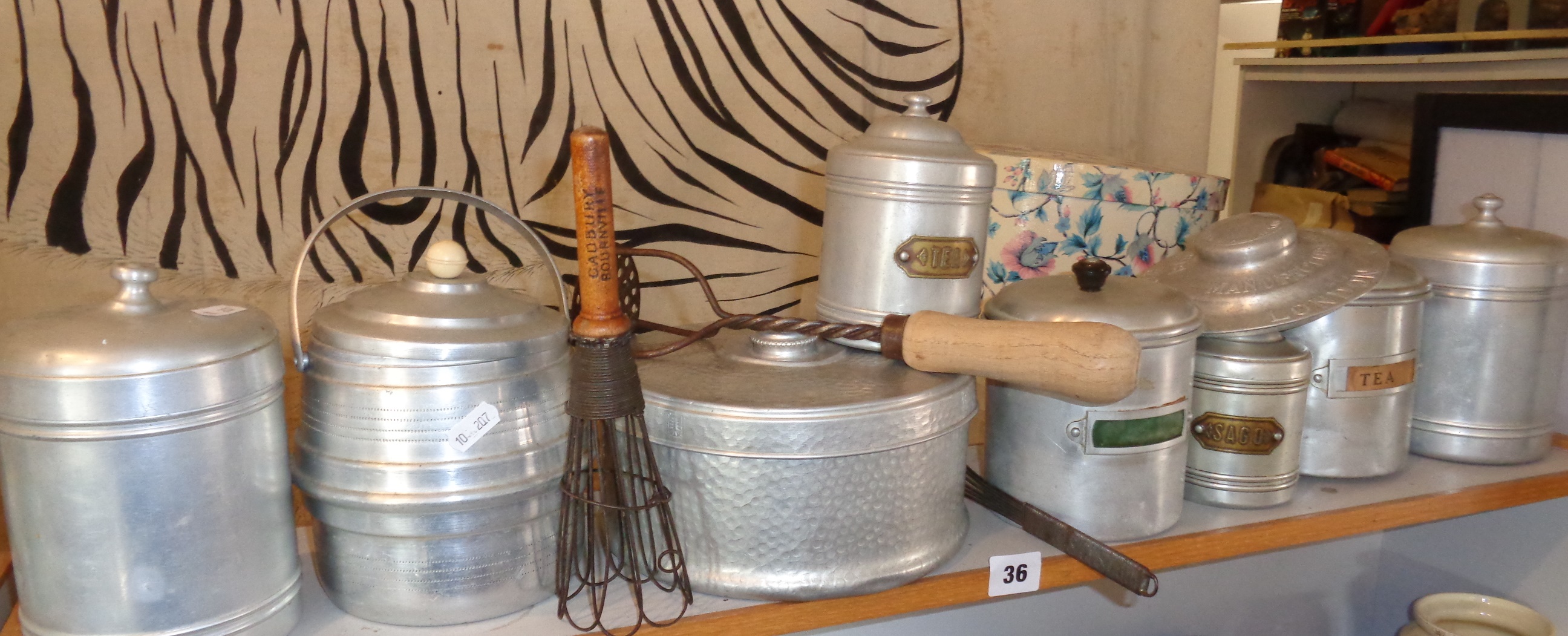 1940's aluminium storage jars (8) including an early Cadbury Bourneville wooden handled whisk