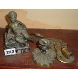 Putti figure set on marble plinth, an ornate brass tie-back and two other brass items