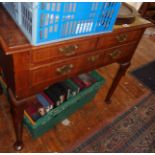 Georgian walnut lowboy having three drawers with brass handles and escutcheons, standing on tapering