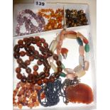 Assorted vintage beaded necklaces, including amber, tiger's -eye, etc.