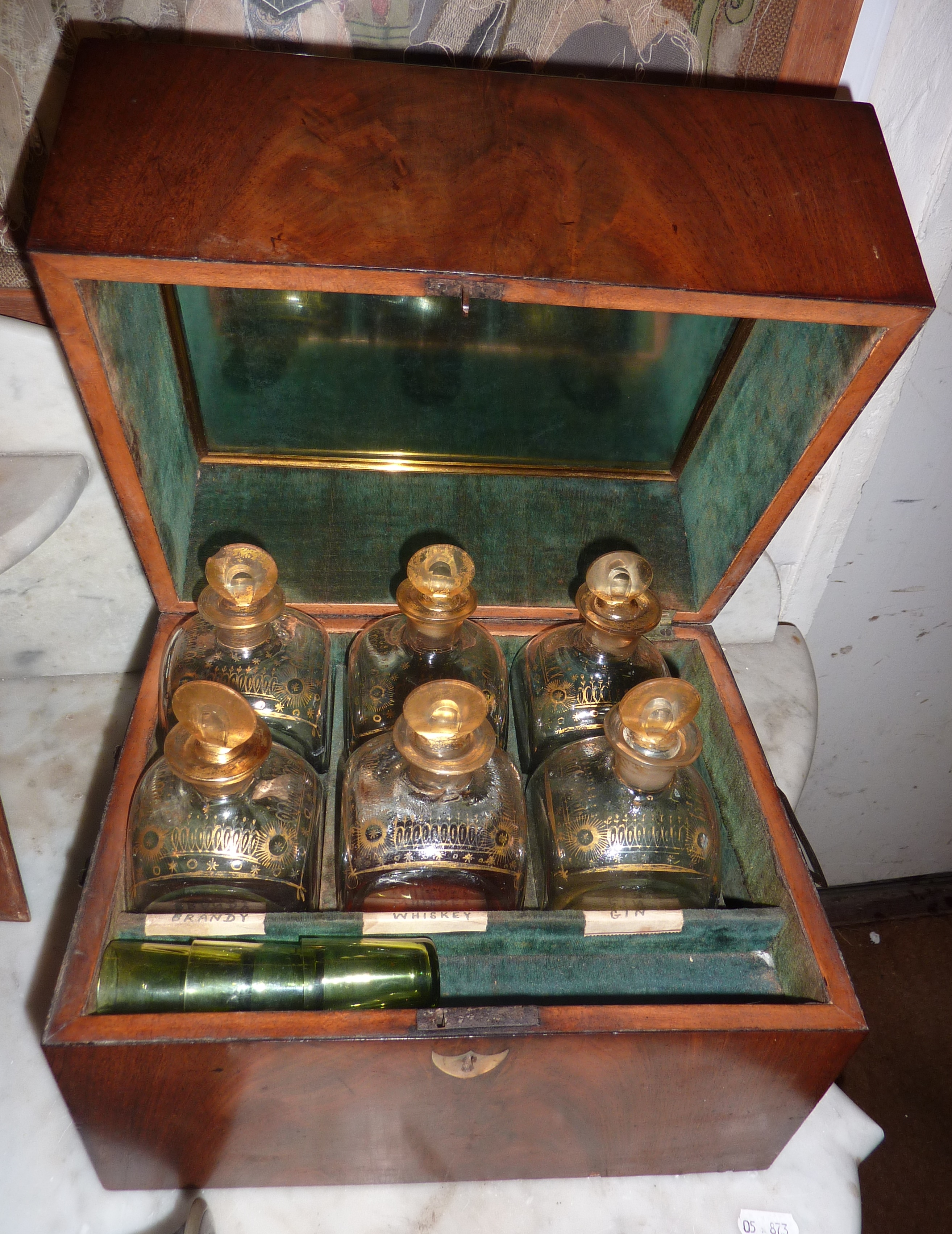 A George lll mahogany decanter box fitted with a collection of six gilt painted decanters and