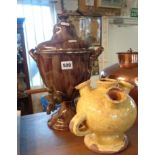 Marbled pottery tea urn and a Continental pottery earthenware vase with four spouts and two handles