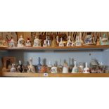 Large collection of china hand bells (two shelves)