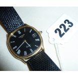 Vintage gentleman's 9ct gold Longines wristwatch with black face and lizard skin strap