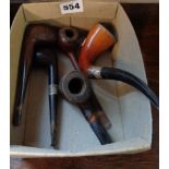 Five old smoking pipes, two with silver bands