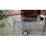 Steel trolley on two wheels with caged compartment