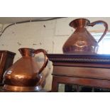 Two large 19th century copper jug measures
