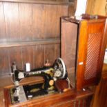 A Singer hand sewing machine in mahogany case