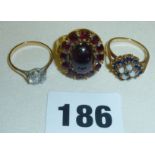 Three 9ct gold rings - one with clear stone, one with red stones & maker's initials "H.B.",