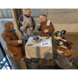 Continental matt-glazed porcelain figures group of Monks serving and eating at a kitchen table,