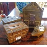 Bronze piggy bank, a brass faced tin 'Bank' money box and two tin money boxes in the form of
