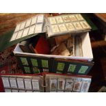 Box containing albums full of cigarette cards including Wills, Gallaher and Players