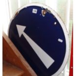 Round enamel traffic sign with white arrow on blue background