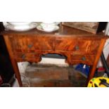 Edwardian walnut kneehole desk with four drawers on square tapering legs