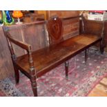 Georgian mahogany bench window seat having shield-shaped panel to back above solid seat on turned