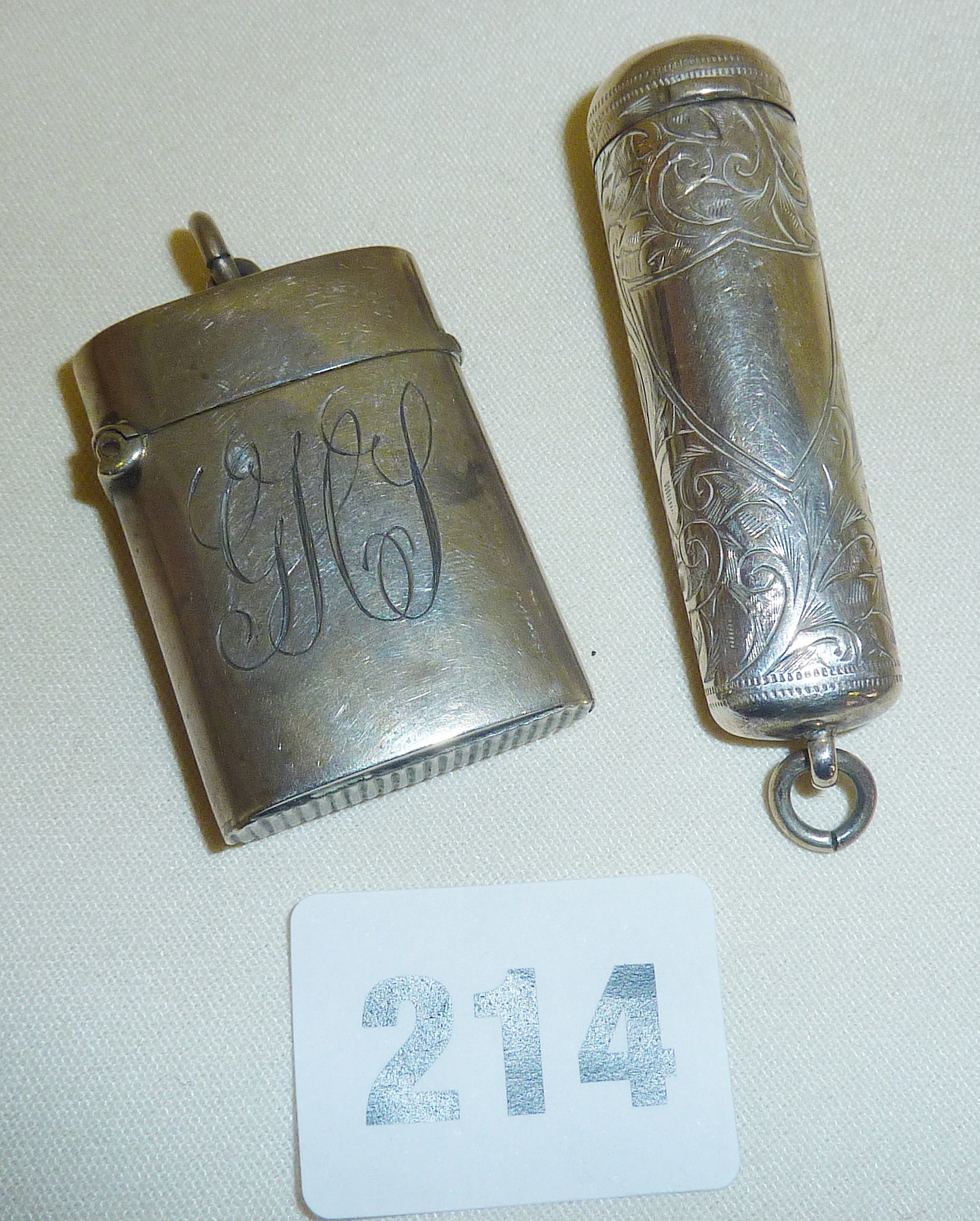 Hallmarked silver fob vesta (Birmingham 1900 by Boots Pure Drug Company), and a silver fob cigar