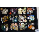 Display case containing old enamel & cloth badges, medals, etc. including Girl Guides, Football,