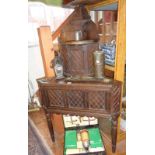 Small Victorian carved oak corner cupboard on turned legs having fall front cupboards