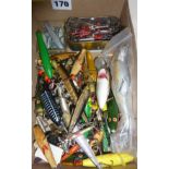 Box of vintage fishing accessories, mainly fish-shaped lures, makers include Heddon, Rapala, ABU