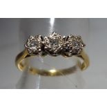 A lady's 18 carat yellow gold ring set with three old cut diamonds, total diamonds approx 15 pt,