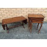 A mahogany coffee table with folding leaves,