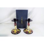 Moorcroft - a pair of Moorcroft candlesticks, approx 18cm (h) boxed and sleeve,