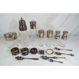 A lot to include good quality plated items comprising dressing table bottles, napkin rings,