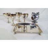 A small silver hallmarked dish raised on four supports, Birmingham assay (62 gram total weight),