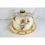 A George Jones and Sons ceramic cheese dish and cover decorated with flowers and bees,