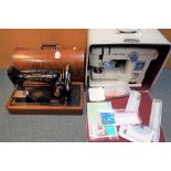 A vintage Singer sewing machine in a wooden case and a cased Janome model 613 sewing machine (2).