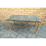 A marble top coffee table with gilded legs 43 cm x 92 cm x 46 cm.