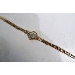 A lady's DAMAS 9ct gold wrist watch with 17 jewel incablock with a 9 ct gold hallmarked strap,