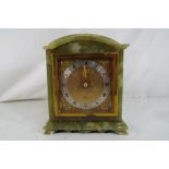 A green onyx cased mantel clock with gilt face,