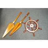 A wood and metal ships wheel with turned handles approx 37cm (diam) and two decorative wall hangers