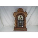 A 19th century American Ansonia eight-day shelf clock with scroll carved oak case, pendulum and key,