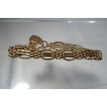 A lady's 9 carat gold gate bracelet with a 9 carat gold safety chain and padlock,