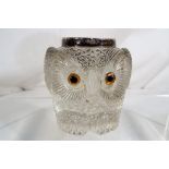A moulded clear glass inkwell in the form of an owl with a silver mount (hallmark rubbed),