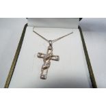 A silver chain with ornate cross.