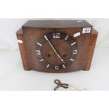 An Art Deco oak cased mantel clock having Arabic numerals to the chapter ring,