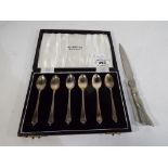 A set of six silver hallmarked Birmingham assay spoons and a white metal letter opener markings