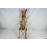A large wooden jointed shelf rabbit,
