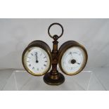 An early 20th century desk compendium of clock and barometer, both with oval white enamel dials,