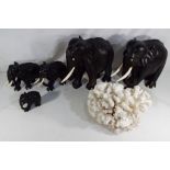 Five carved ebony elephants and a piece of coral,