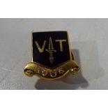 A hallmarked 9 carat gold enamelled lapel badge marked VT 1906, approximate weight 7.