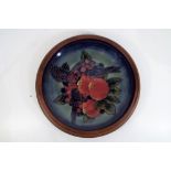 Moorcroft - a large ceramic Moorcroft plaque with wooden surround, approx 29cm (d),