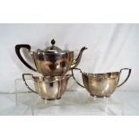 A George IV hallmarked silver teaset comprising teapot, sugar bowl and creamer,