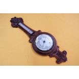 An oak cased Android Banjo barometer with carved detailing, approximate height 90 cm.