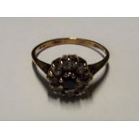 A lady's 9 carat yellow gold diamond and sapphire cluster ring size M and a half,